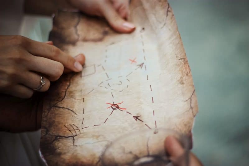 finger pointing at treasure map
