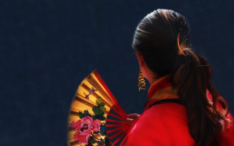 woman holding chinese fan