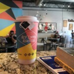 reading and writing at coffee shop