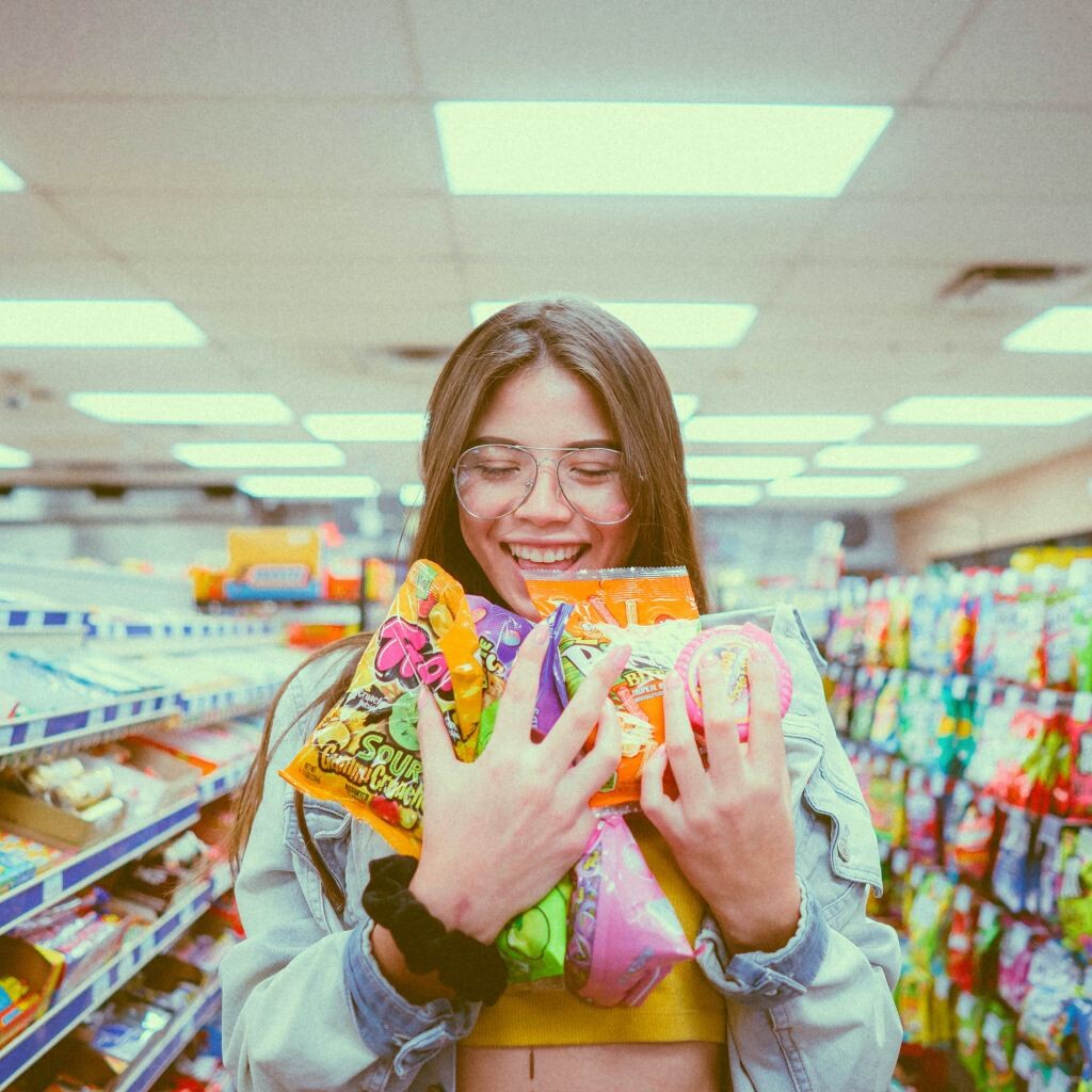 girl holding candies inside store